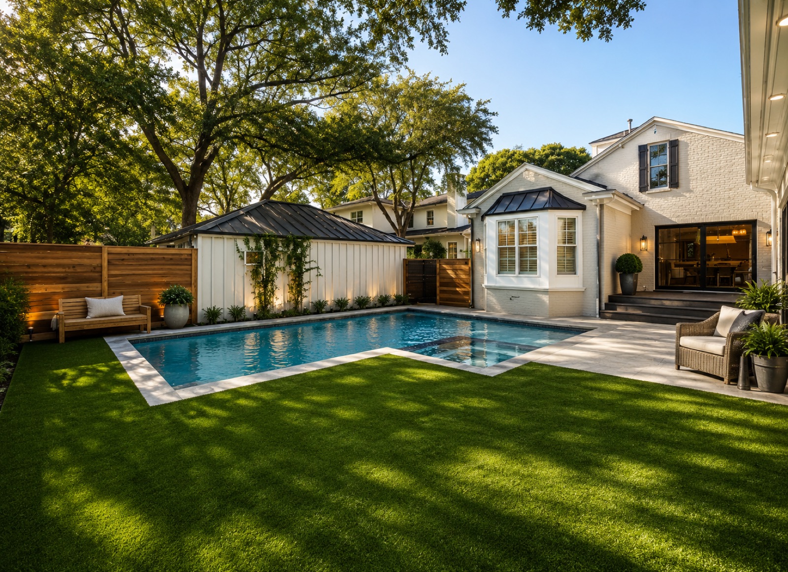 A swimming pool bordered by an artificial-turf lawn